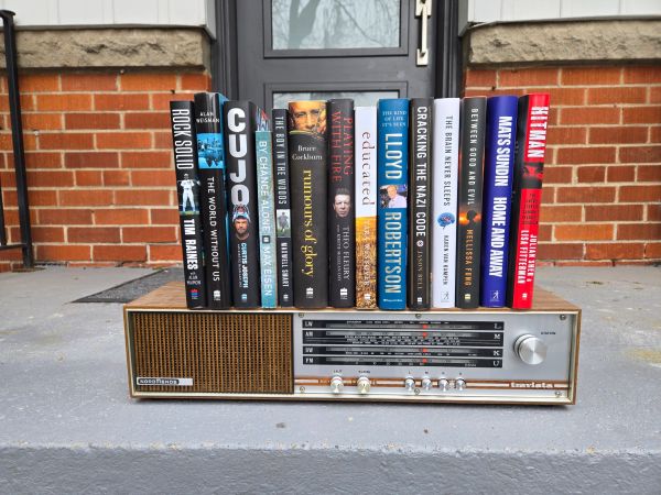 Titles edited by Jim Gifford, standing on a vintage radio